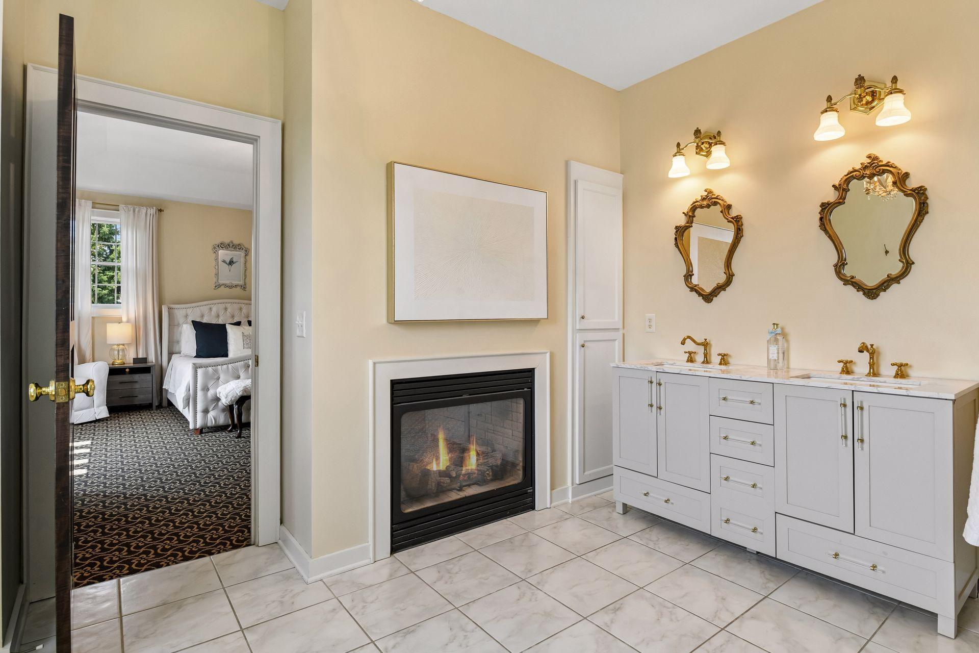 The Primary Bathroom enjoys a see-through fireplace and designer vanity.