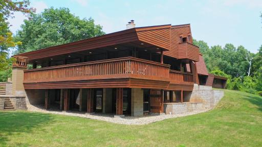 Cedar siding with a massive architecturally designed deck support system. An upstairs deck on the upper level on each end of the home