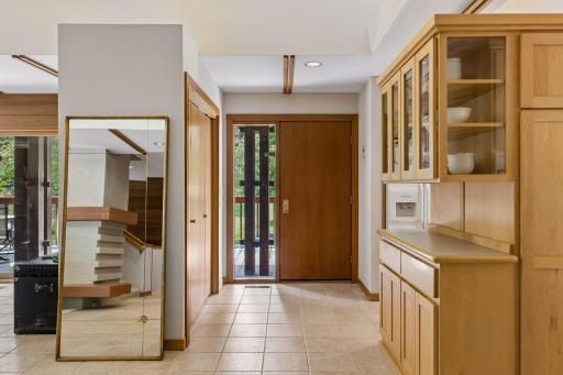 Tiled entry-way from outside deck. Home has heavy, solid-wood doors, maple millwork & cabinetry throughout every level. The central vacuum system is located throughout the home and in the 3-car garage.
