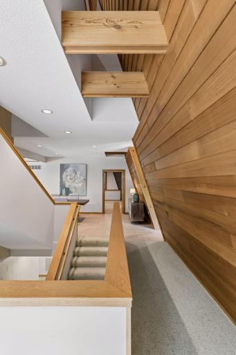 Architecturally angled redwood wall with open ceiling 18 feet high to upper level