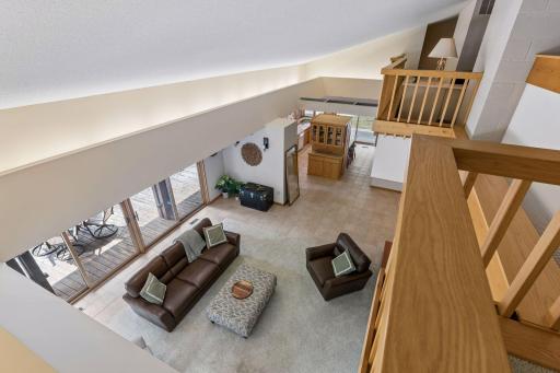 Hallway on the upper level overlooking the open ceiling of the Living room