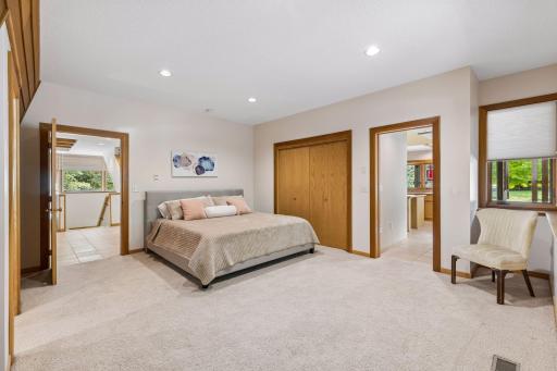 Primary bedroom on the main level of the home with an architecturally angled redwood wall