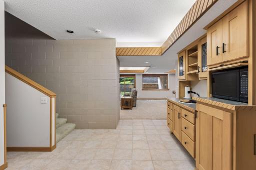 Lower-level all with in-floor geothermal heating and tiled floor in the wet bar area