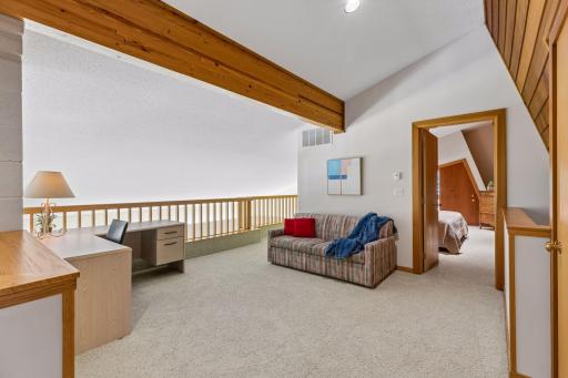 Upper-level mezzanine with bedroom through doorway