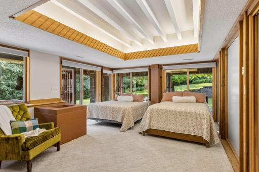 Lower-level bedroom with recessed lighting and 3 sliding glass doors to the outside for lots of natural sunlight