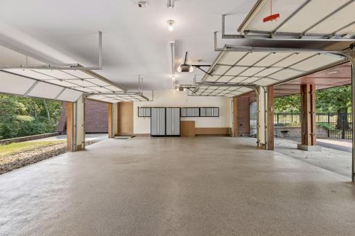 Central vacuum with an epoxied floor. Wall-mounted PERFORMAX cabinets on either end of the garage