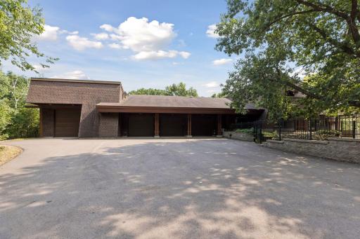 Outside view of four of the overhead garage/workshop doors with ample outside parking