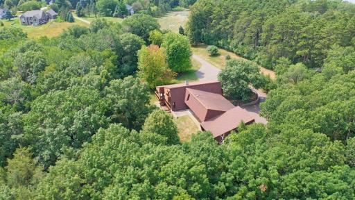 360-degree privacy of home. The Troy Burne Golf Village private 10-acre park with recreational equipment and a Pickleball court is connected to one side of the approximately 725-foot asphalt driveway.