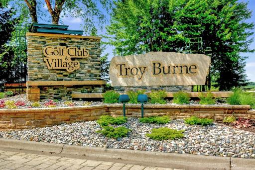Home is tucked away on a private nearly 5-acre, wooded lot, adjacent to the golf course in Troy Burne Golf Club and Village development.