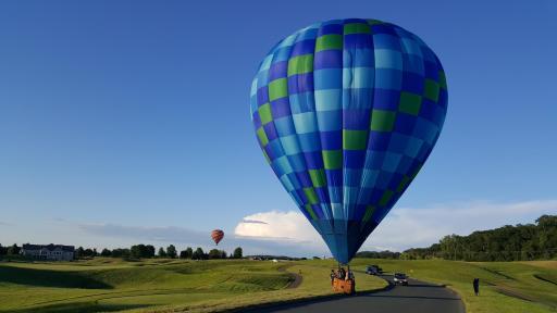 Hot air balloons fly low over the golf course, occasionally landing on the Troy Burne Golf Course as this one did along the 9th fairway