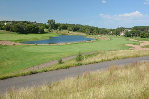 Both the golf cart path and the walking path parallel the 10th fairway and the pond.