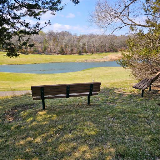 The private walking path offers shaded benches overlooking the signature golf course, the back 9 holes.