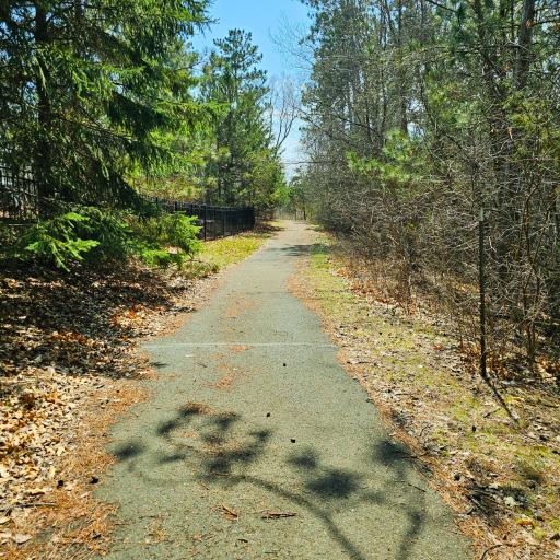 Walking paths run through both wooded areas and along the golf course.