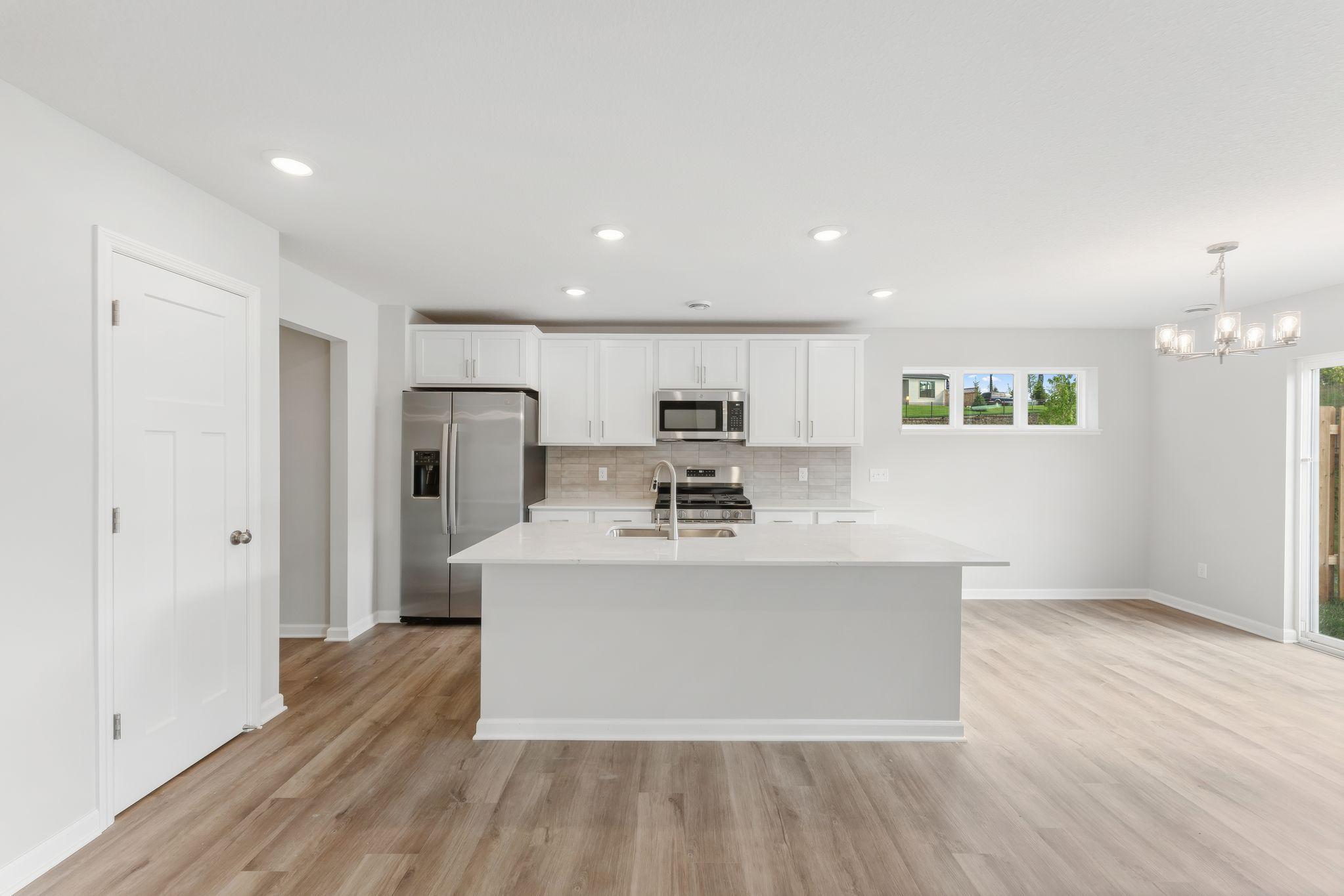 Lots of cabinet space, tiled backsplash, and pantry! (Photos are for representation only, colors and materials may vary in actual home.)