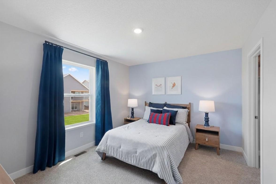 All three of the other upstairs bedrooms are large and feature walk-in closets!! Model photo, options and colors may vary.