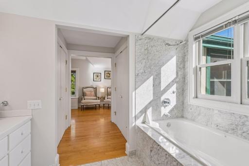 Bright hallway framed by a marble-clad architectural detail and views into the adjoining room.