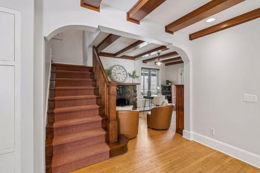 Grand staircase and arched passageway create a memorable transition between the home's main living spaces.