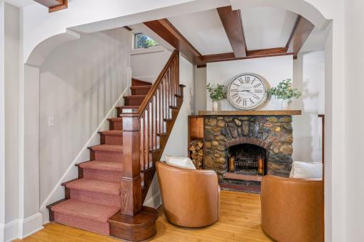 Character-rich staircase anchored by a stone fireplace and rich wood detailing.