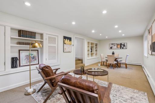Spacious lower-level family room combining a dining area, lounge seating, and abundant storage.