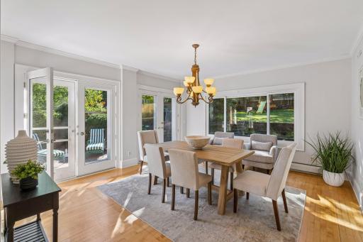 Spacious dining setting surrounded by windows and natural light.