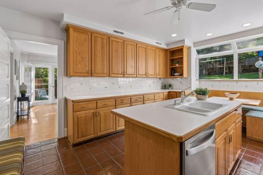 Well-appointed kitchen with warm wood cabinetry, a generous island, and bright garden views.