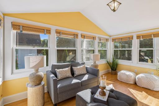 Inviting sunroom with expansive windows, comfortable seating, and garden views.