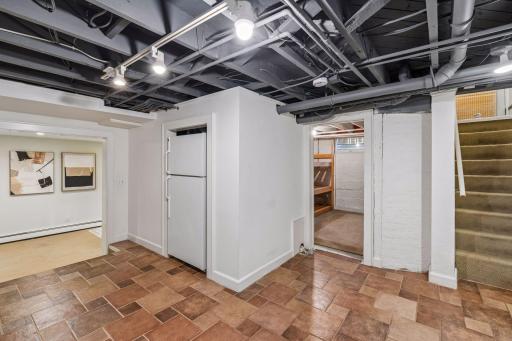 Functional lower-level passage with durable flooring and convenient storage areas.