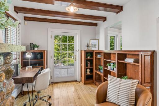 Versatile study with built-in shelving, French doors, and views toward the outdoors.