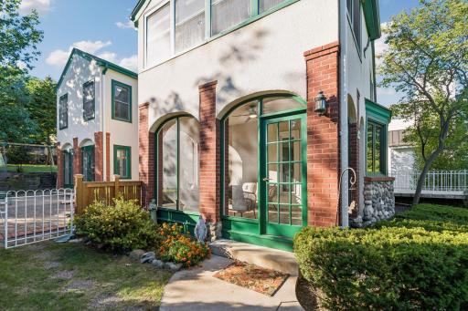 Distinctive brick-and-stucco exterior accented by arched windows and vibrant green trim.