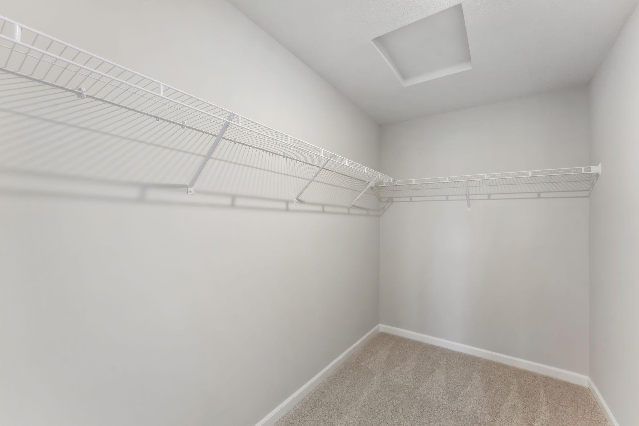 Large primary closet has so much space for all your clothes! (Pics are for representation only, colors and materials may vary in actual home.)