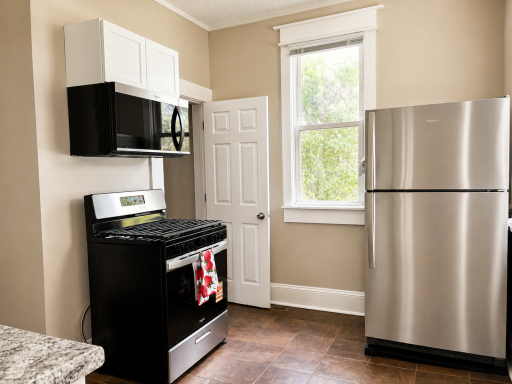 Sun-lit Kitchen, new Stainless Appliances, leads to the Porch