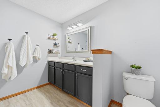 The full bathroom features a spacious vanity, a tub/shower combination, and a partioned water closet for added convenience. With ample counter space and room to move, it's designed to make busy mornings and daily routines a breeze.