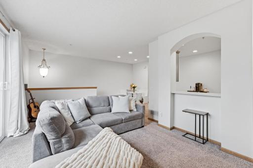 Bathed in natural light, this inviting room offers exceptional flexibility and can easily accommodate a variety of furniture arrangements to suit your lifestyle.