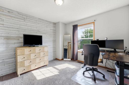 Retreat upstairs to two spacious bedrooms, thoughtfully designed to provide comfort, privacy, and a peaceful place to unwind. This bedroom is currently being used as a home office.