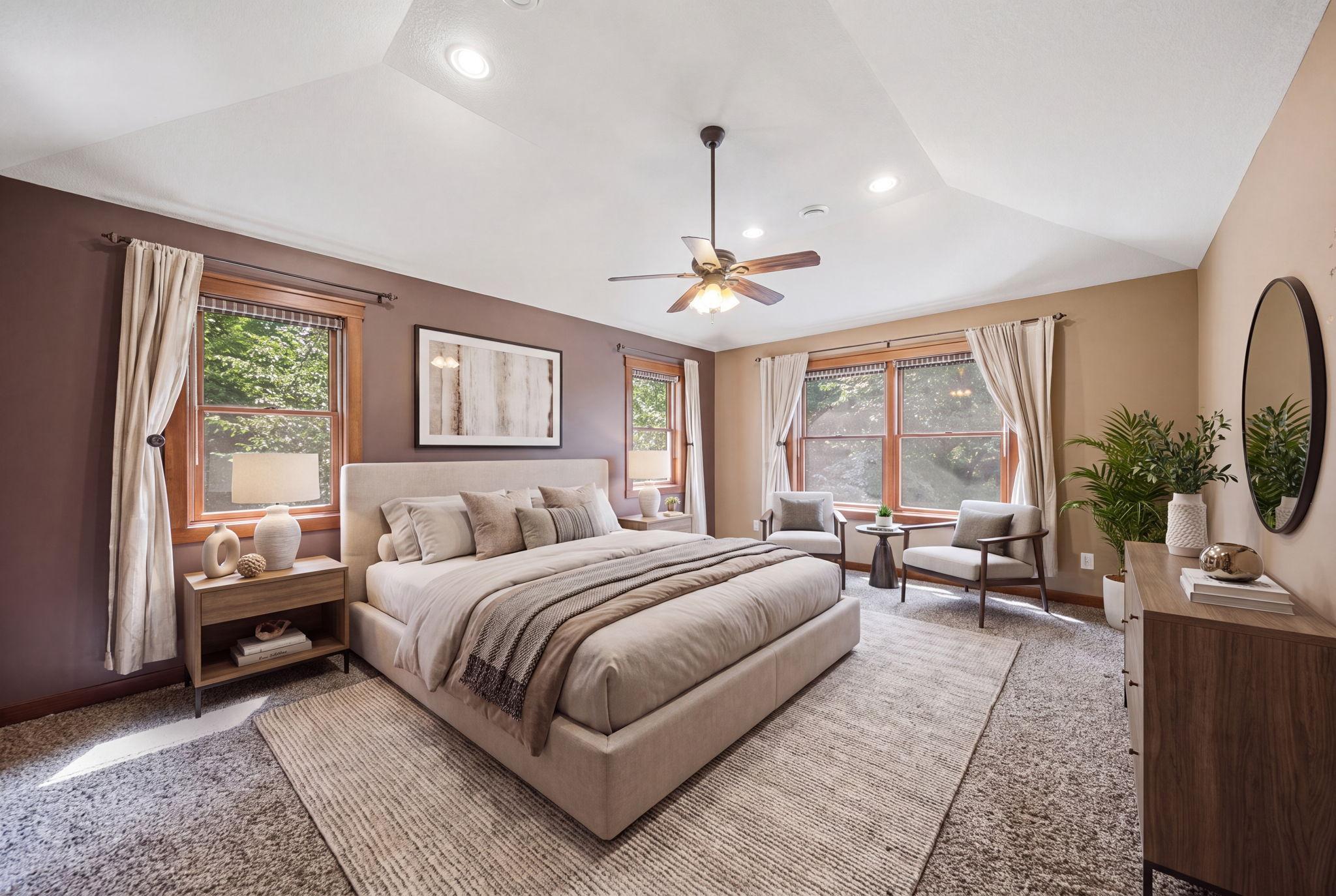 Private owner’s suite featuring a walk-in closet and ensuite bath with double vanities, a jetted tub, and walk-in shower. (virtually staged)
