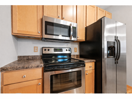 Modern kitchen with stainless appliances.