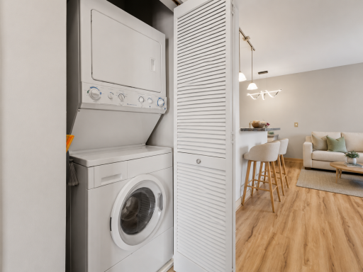 In unit washer and dryer makes laundry convinient. Different barstools and couch virtually added.