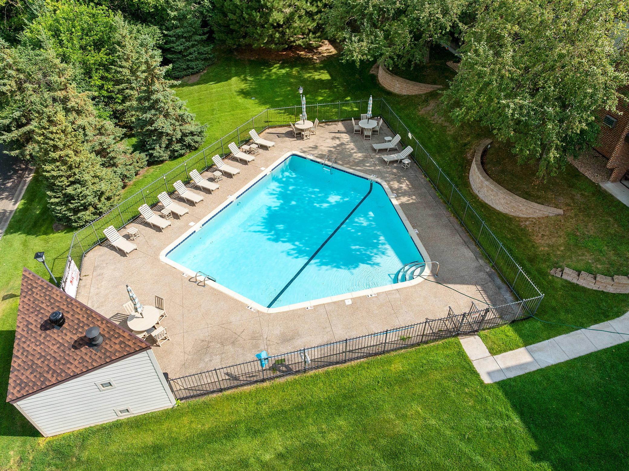 The large, well-maintained heated in-ground pool, complete with pool house and spacious concrete deck.