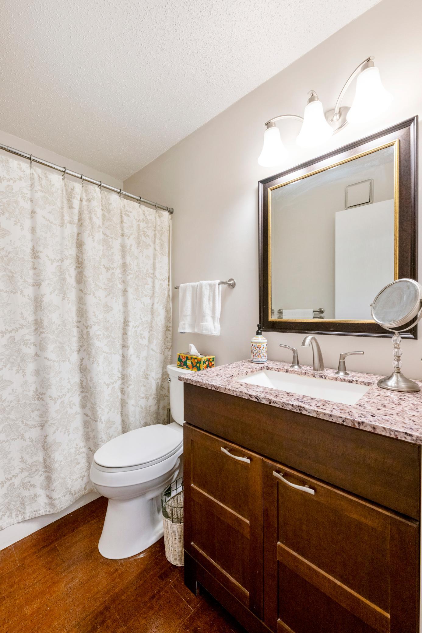 Lovely full bath with updated vanity, flooring and lighting.