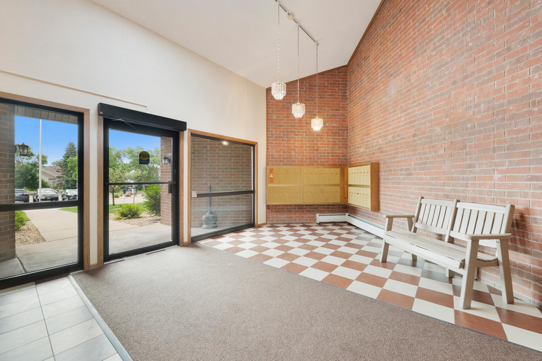 A large, well-lit front foyer of brick and tile welcomes your guests.