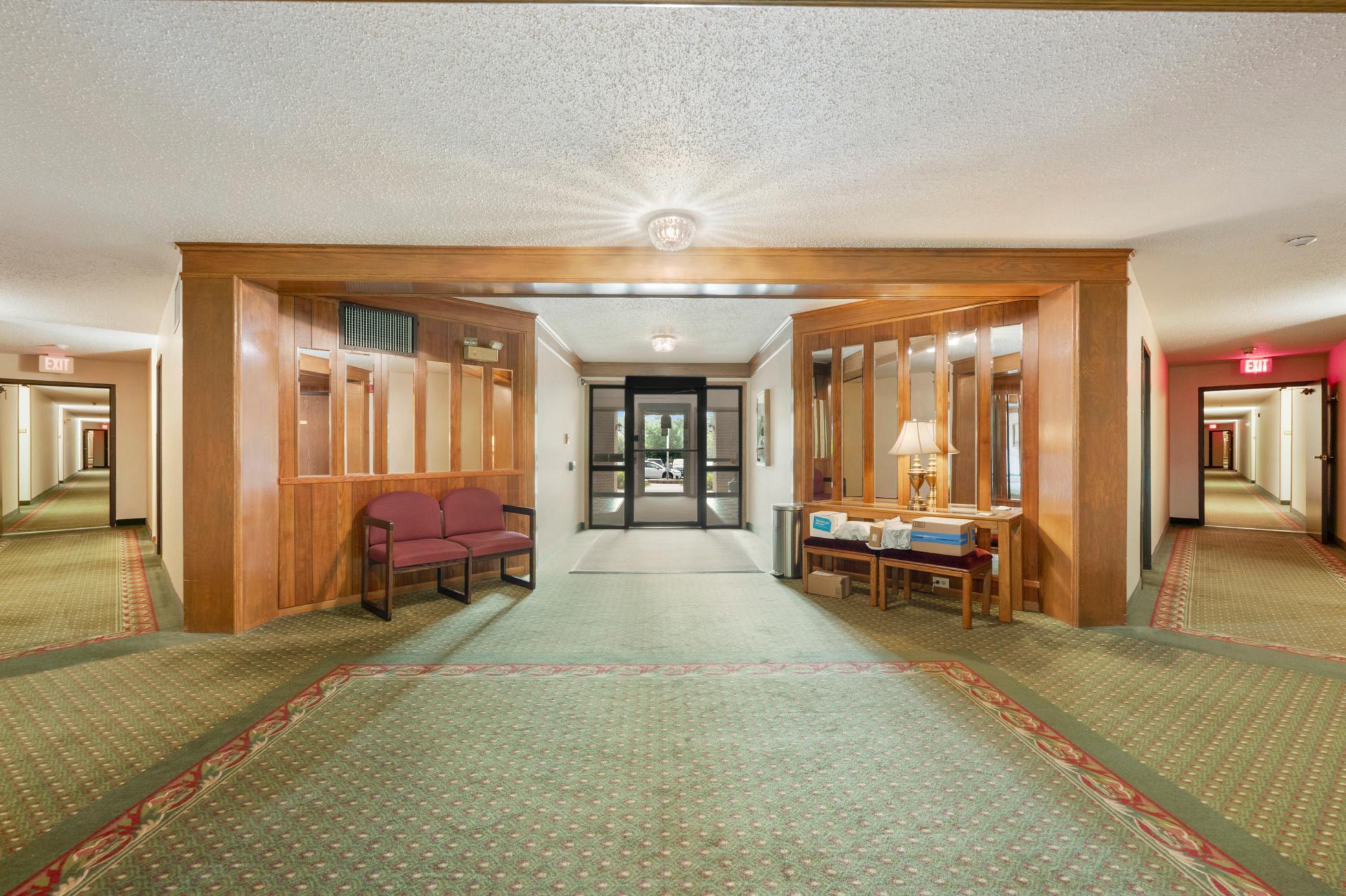 Spacious, well-lit main lobby which leads to the elevator and party room directly ahead plus the outdoor pool down the hall to the left.