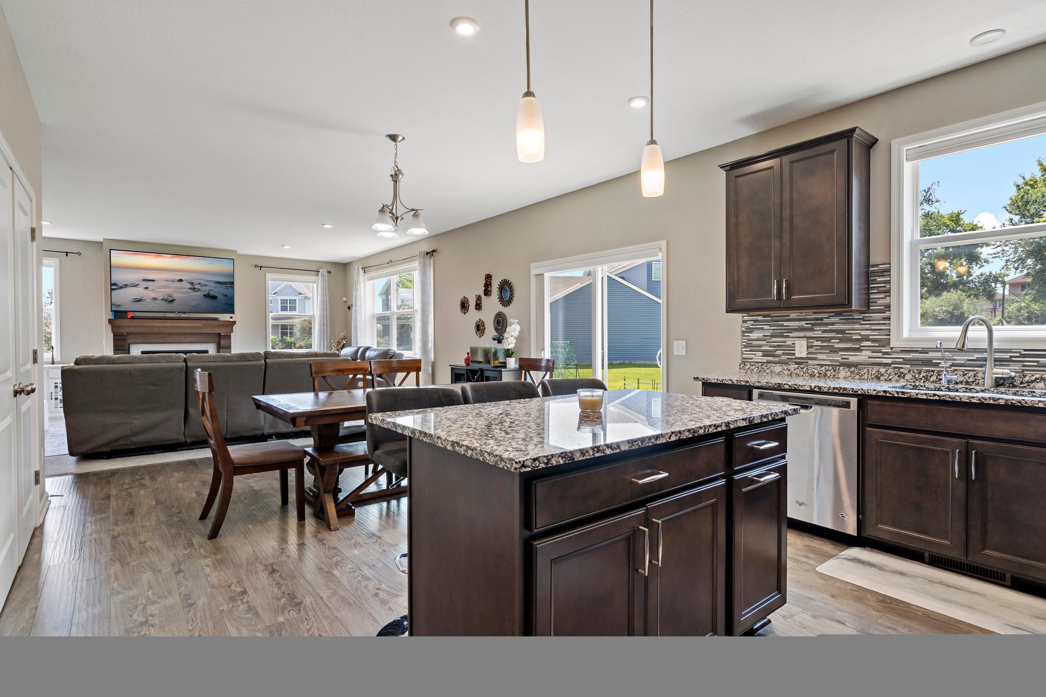 Granite countertops, pendant lighting, LVP flooring, stainless steel appliances.