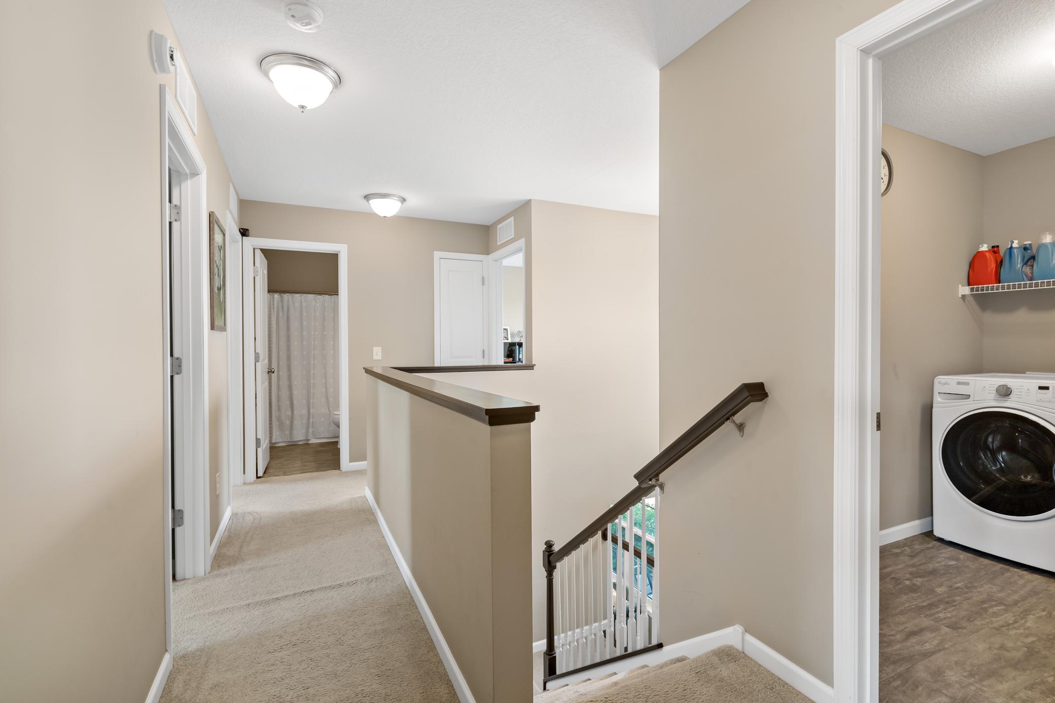 Upon ascending the stairs, this open hallway leads to all four bedrooms and the upper level laundry room.