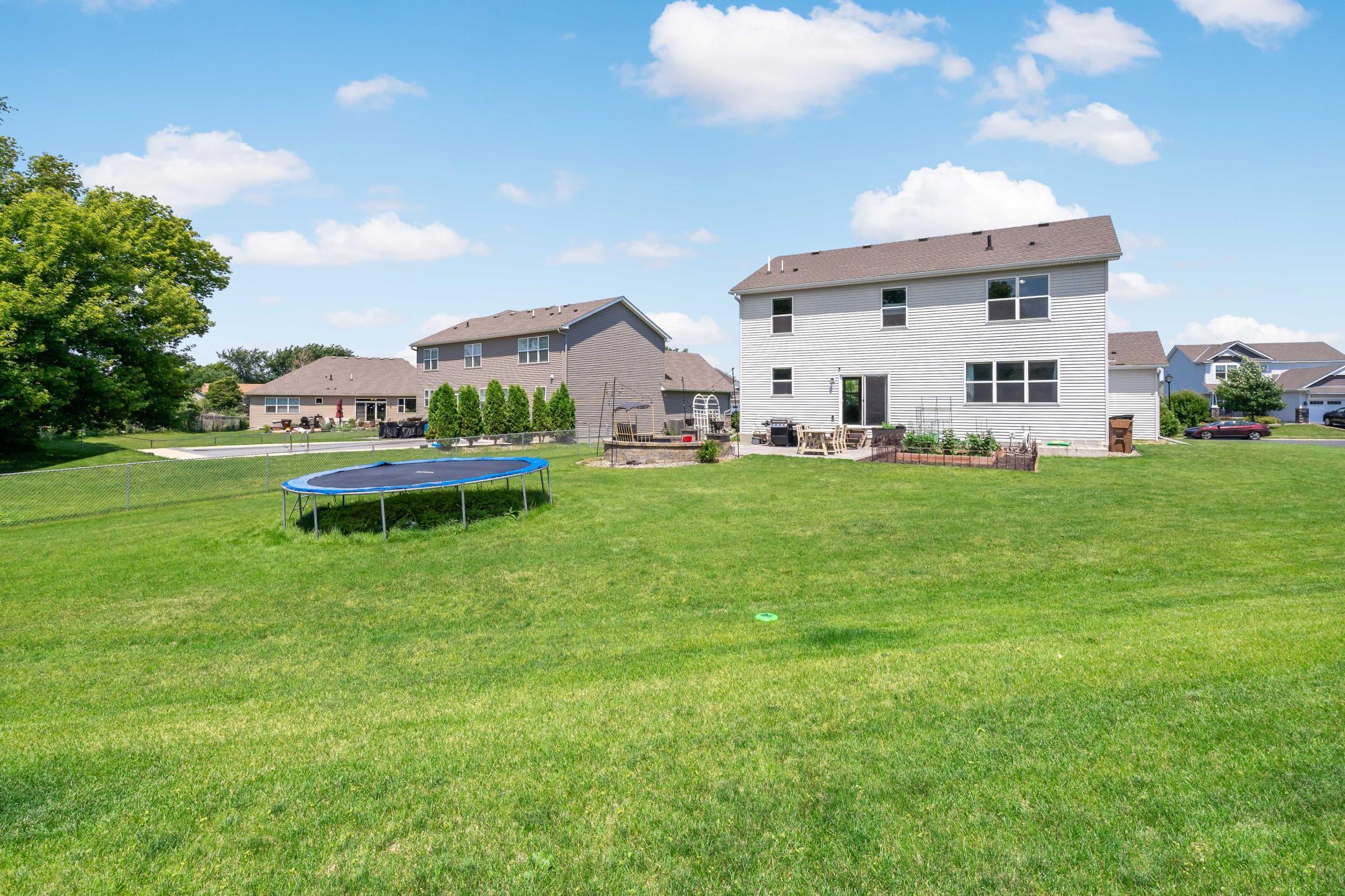 Large, flat back yard awaits BBQs, soccer games, and many rounds of playing catch.