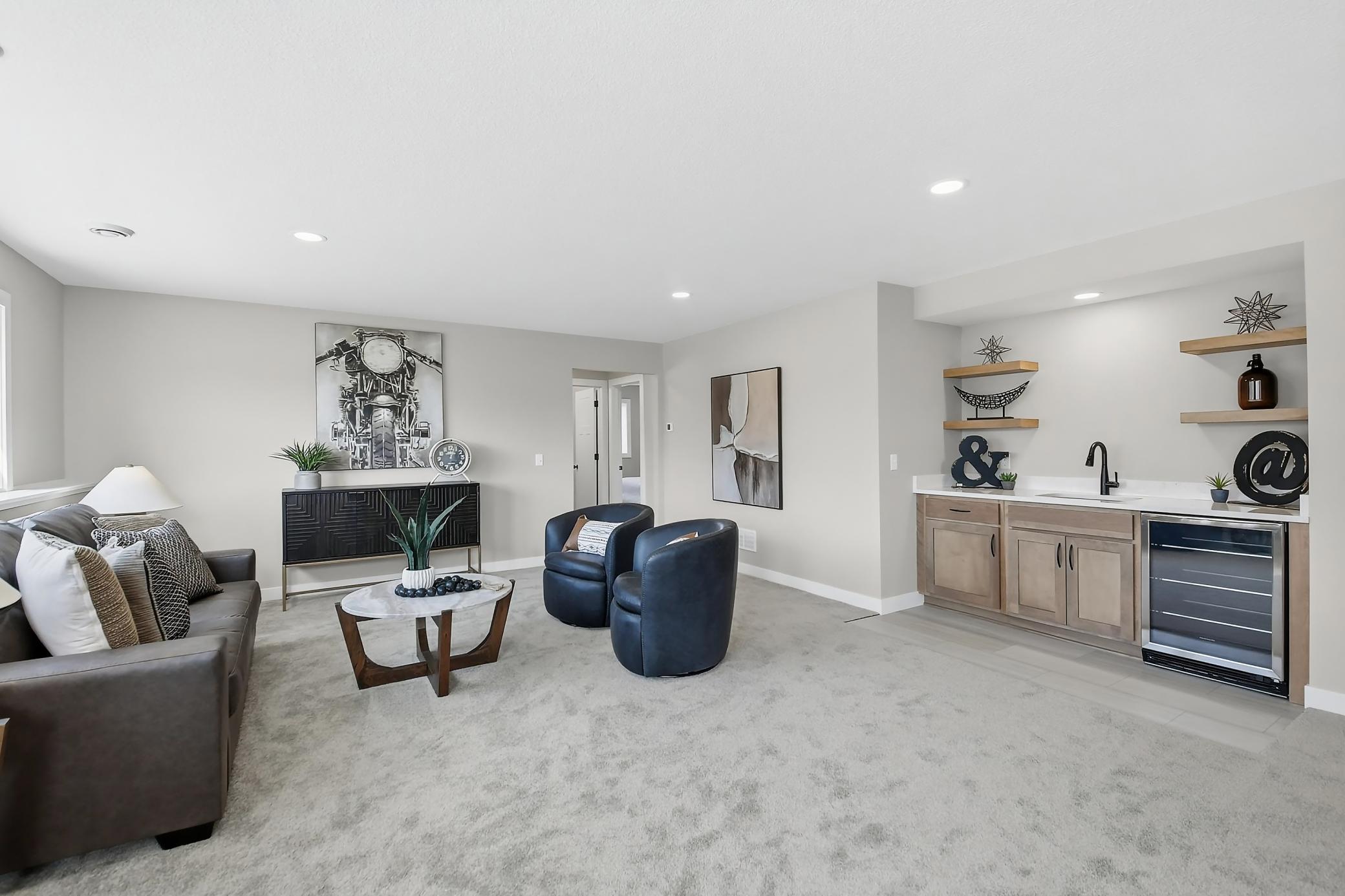 This lower level family room offers a wet bar and an abundance of sunlight.