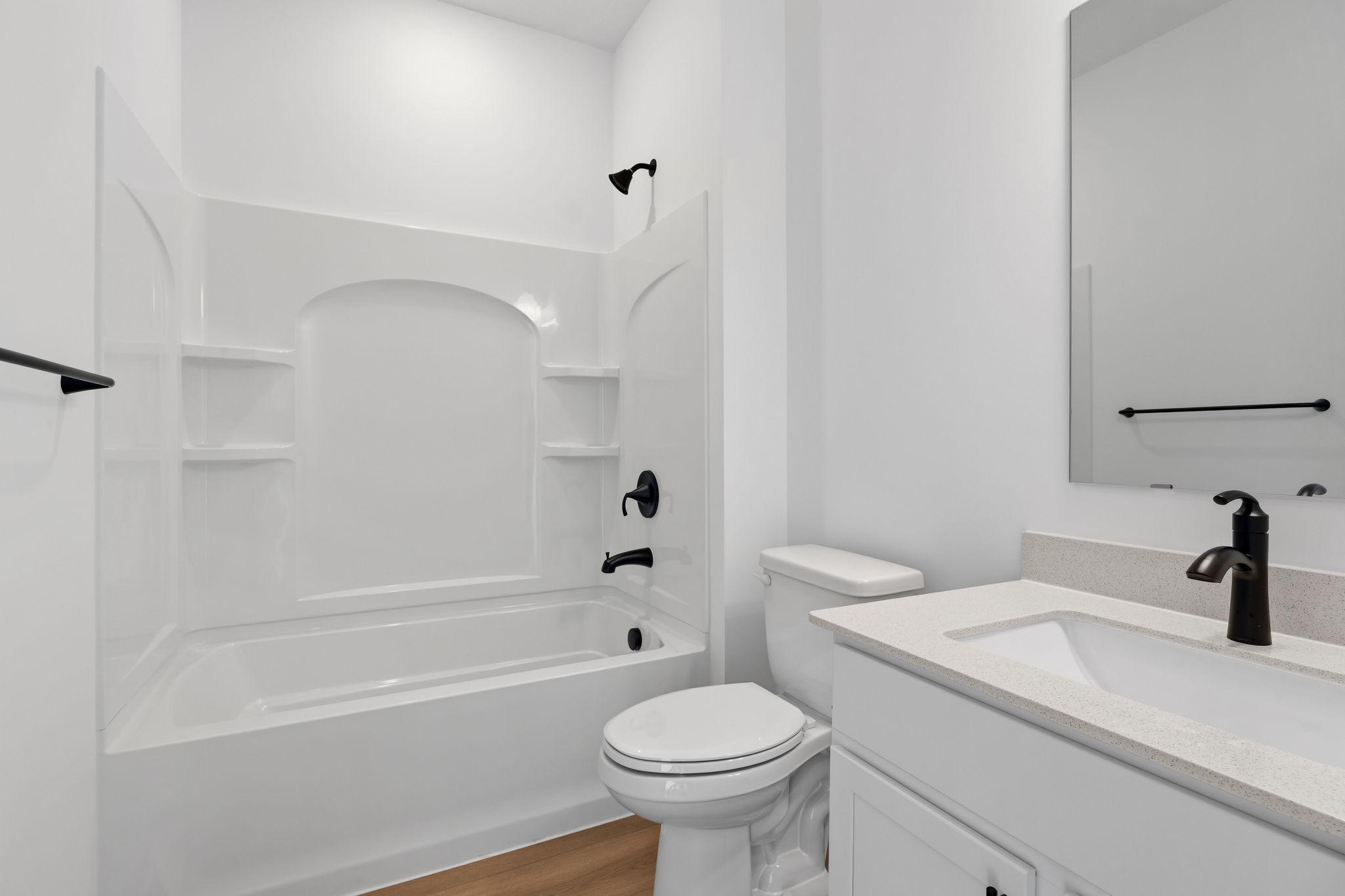 This shared full bathroom is easily accessible from the open floorplan for guest and daytime use.