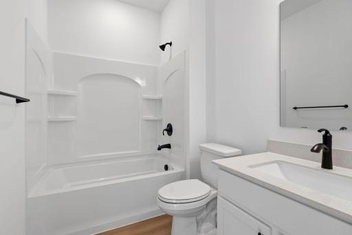 This shared full bathroom is easily accessible from the open floorplan for guest and daytime use.