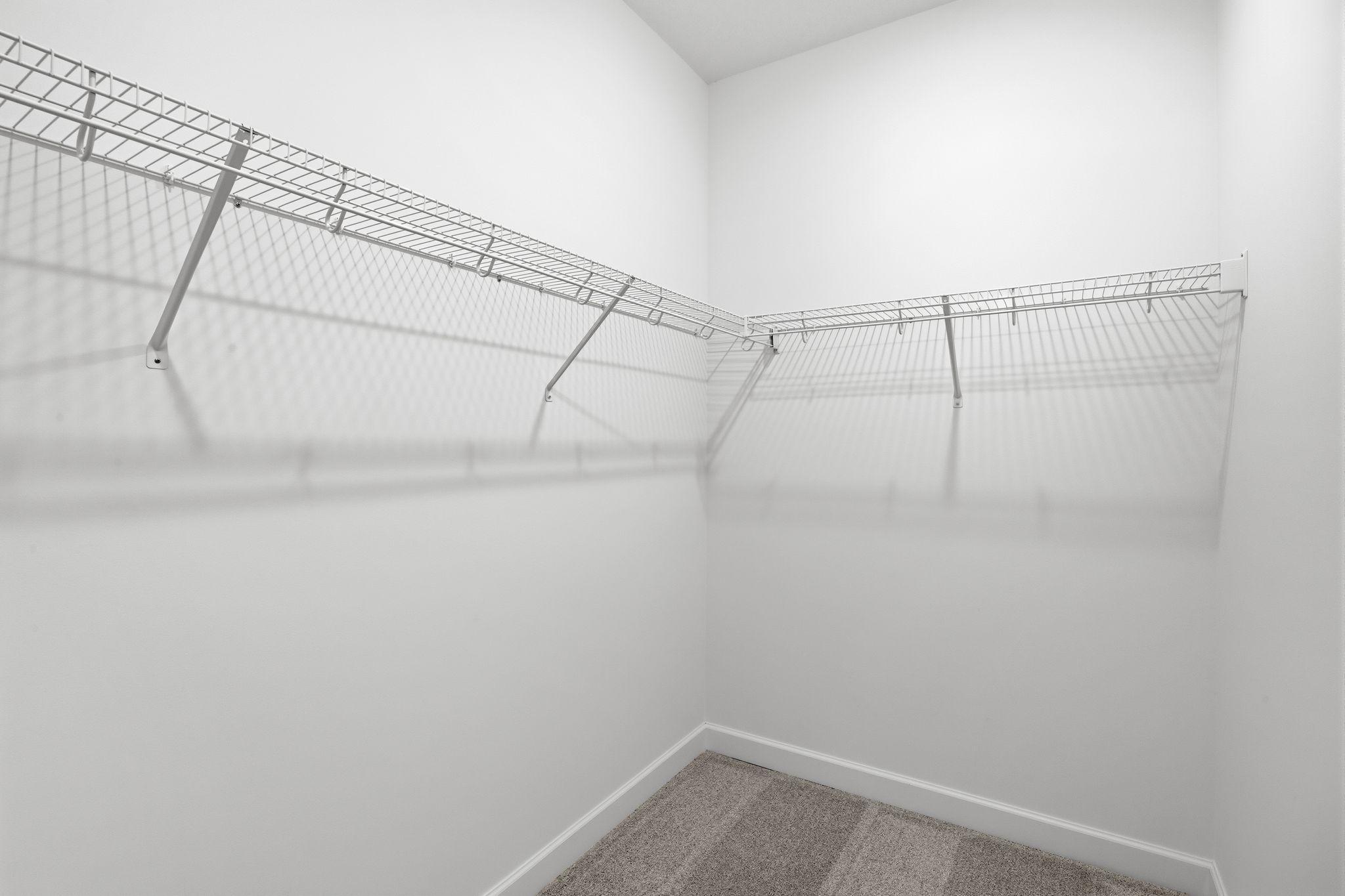 Fit for any fashion enthusiast, the walk-in closet offers ample wardrobe storage