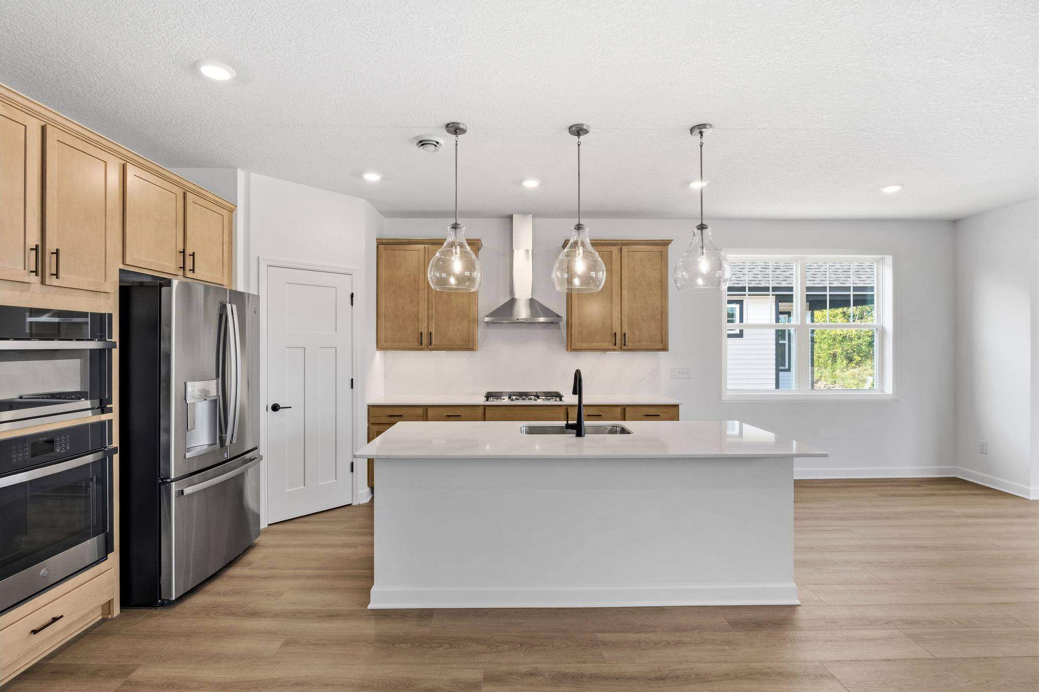 With plenty of cabinetry storage and a convenient corner pantry, everything is both within reach and out of sight at the same time
