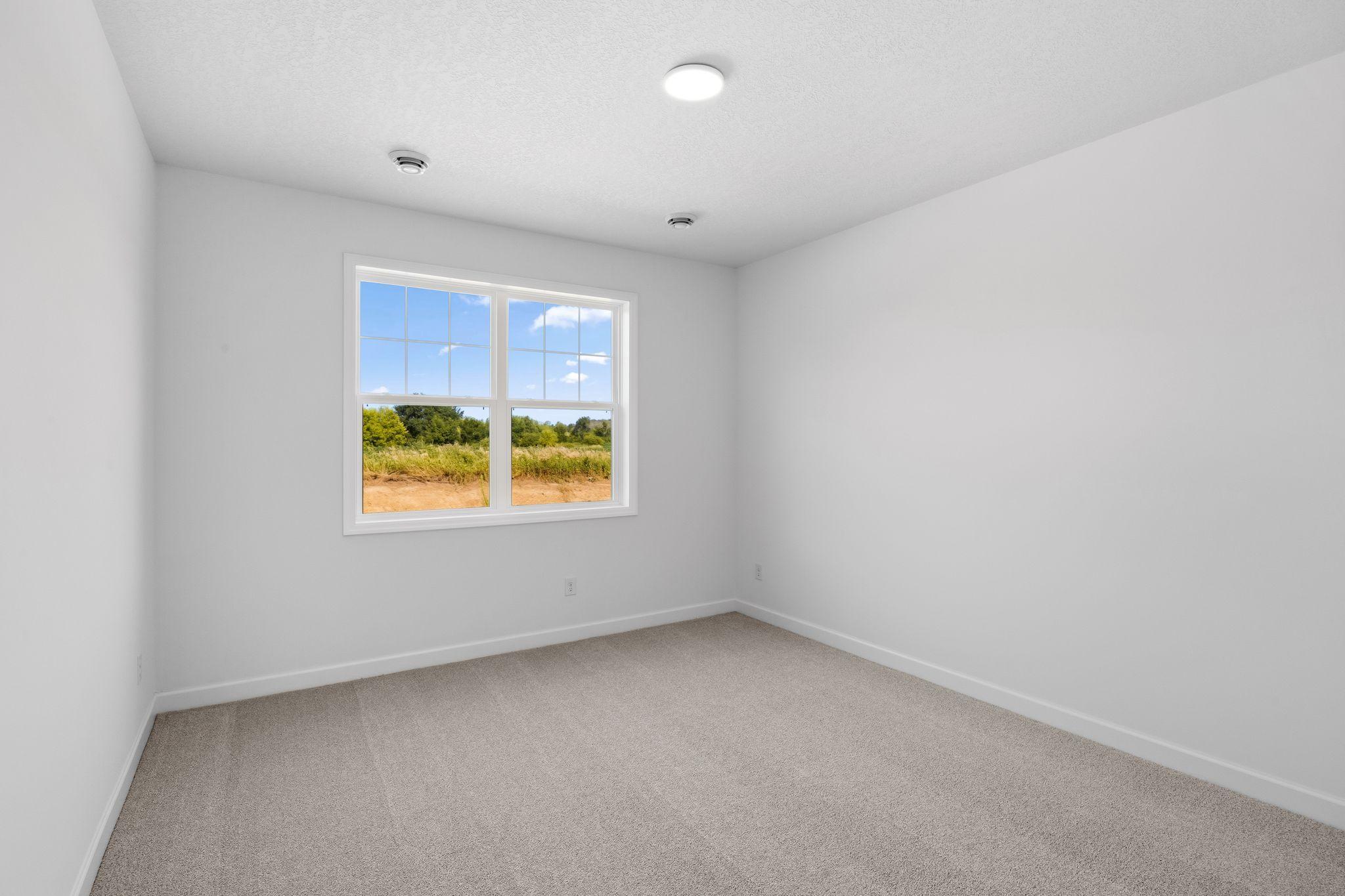 The owner’s suite enjoys a private location at the back of the home, complete with a restful bedroom, an en-suite bathroom and a walk-in closet.